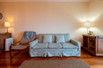 a living room with a couch and a chair at Caniço Quintas III by Trip2Portugal in Caniço