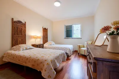 a bedroom with two beds and a mirror at Caniço Quintas III by Trip2Portugal in Caniço