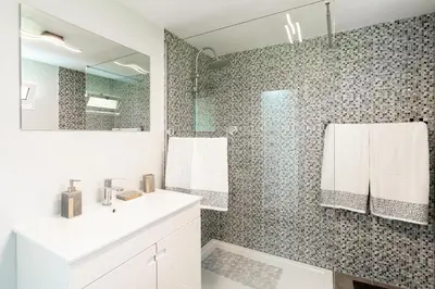 a bathroom with a white sink and a shower at Casa Miradouro do Pigarro, Sunny Apartment in Calheta
