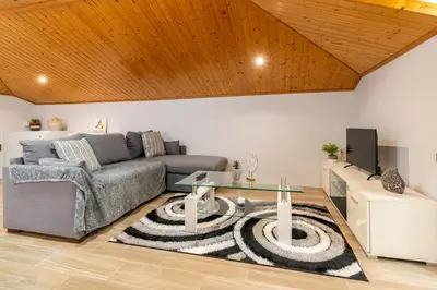 a living room with a couch and a table at Casa Miradouro do Pigarro, Sunny Apartment in Calheta