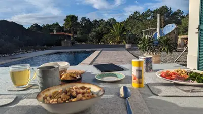 a kitchen with wooden cabinets and a stove top oven at Villa Atlantico in Aljezur