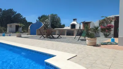 a swimming pool in front of a house at Villa Atlantico in Aljezur