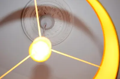 a light hanging from a ceiling with a yellow wand at VILA ALEGRIA in Funchal