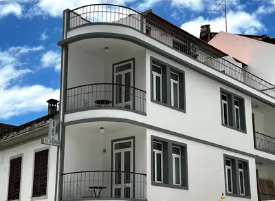 a white building with a balcony on top of it at VILA ALEGRIA in Funchal