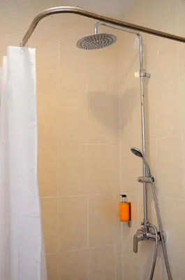 a shower in a bathroom with a shower curtain at VILA ALEGRIA in Funchal