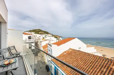 a balcony with a view of the beach at Frontline Seaview Apartment in Budens
