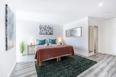 a living room with a blue couch and a table at Frontline Seaview Apartment in Budens