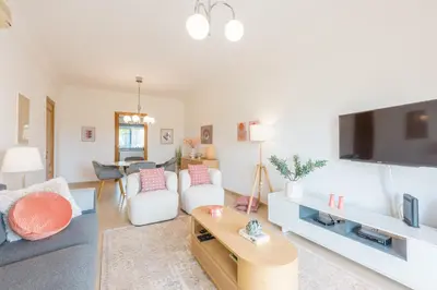a living room with a couch and a tv at Boavista Charming Apartment in Lagos