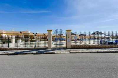 a fence in front of a building with a parking lot at Boavista Charming Apartment in Lagos