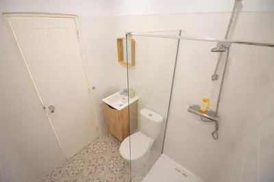 a small bathroom with a toilet and a shower at Casa Jana 5 Bedroom House for 12 with Ocean View Terrace near the Beach in Burgau
