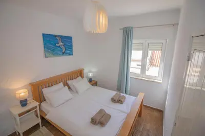 a bedroom with a bed with two towels on it at Casa Jana 5 Bedroom House for 12 with Ocean View Terrace near the Beach in Burgau