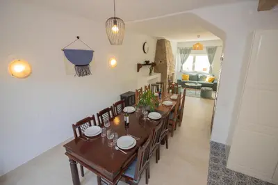 a dining room with a long table and chairs at Casa Jana 5 Bedroom House for 12 with Ocean View Terrace near the Beach in Burgau