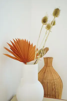 two vases sitting on a table with flowers in them at Birds of Paradise - Boutique Surf Lodge in Aljezur