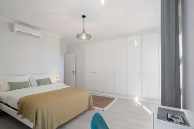 a bedroom with a bed and a large window at Intelsol Calheta Apartments by An Island Apart in Calheta