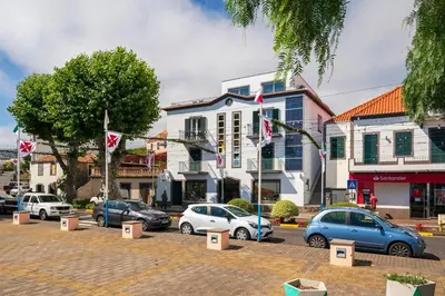 a group of cars parked in a parking lot at Intelsol Calheta Apartments by An Island Apart in Calheta