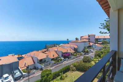 a view from a balcony of a town with the ocean at Madeira Ocean View by Atlantic Holiday in Caniço