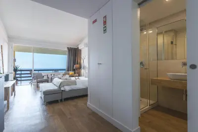 a living room with a bed and a bathroom at Madeira Ocean View by Atlantic Holiday in Caniço