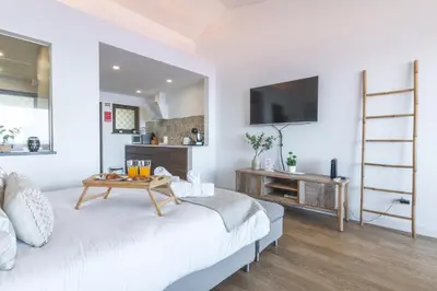 a white living room with a table on a bed at Madeira Ocean View by Atlantic Holiday in Caniço