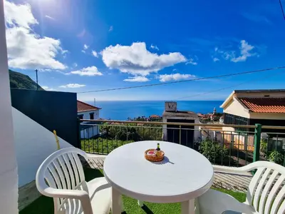 a white table and two chairs on a balcony at Casa Torbit, Apartment in Arco da Calheta in Arco da Calheta