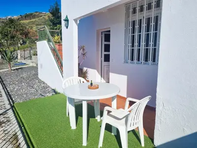 a white table and two chairs on a patio at Casa Torbit, Apartment in Arco da Calheta in Arco da Calheta