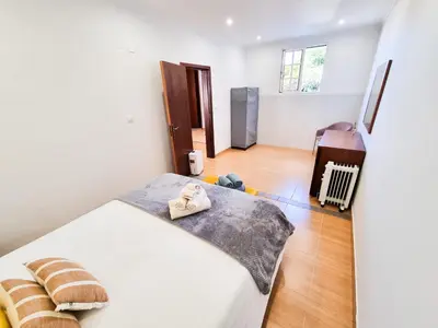 a bedroom with a bed with two shoes on it at Casa Torbit, Apartment in Arco da Calheta in Arco da Calheta