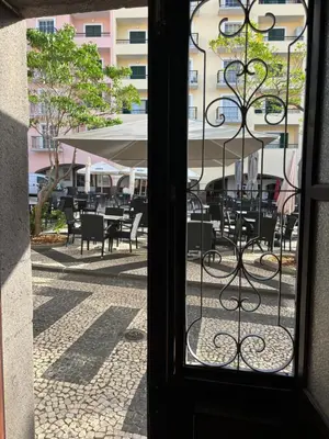 an open door to a patio with tables and chairs at Cc39-Q4 in Funchal