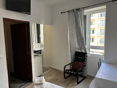 a living room with a chair and a window at Cc39-Q4 in Funchal