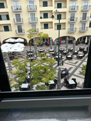 a view from a window of a courtyard with tables and chairs at Cc39-Q4 in Funchal