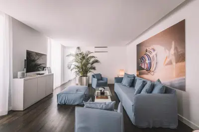 a living room with a blue couch and chairs at QUINTA TORRINHA LUXODREAM Apartment in Funchal