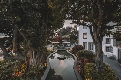 a pool in the middle of a yard with trees at QUINTA TORRINHA LUXODREAM Apartment in Funchal