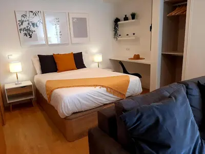 a bedroom with a bed and a couch at Superb Sea View Flat in Funchal in Funchal