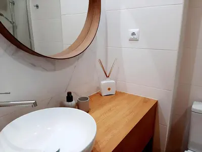 a bathroom with a white toilet and a mirror at Superb Sea View Flat in Funchal in Funchal