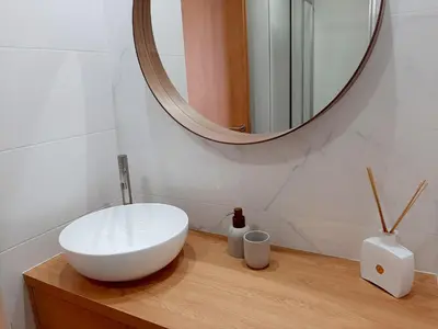 a bathroom with a white sink and a mirror at Superb Sea View Flat in Funchal in Funchal