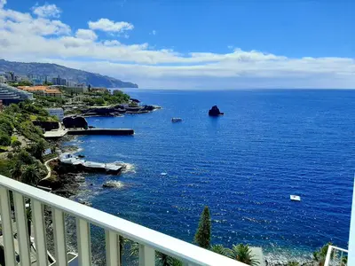a view of a large body of water from a balcony at Superb Sea View Flat in Funchal in Funchal