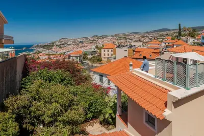 a man standing on the roof of a building at Vila Boa Vista by An Island Apart in Funchal