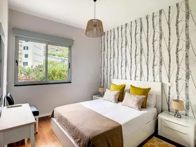 a bedroom with a bed and a window at Alameda Apartment by LovelyStay in Funchal