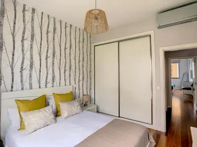 a bedroom with a white bed with yellow pillows at Alameda Apartment by LovelyStay in Funchal