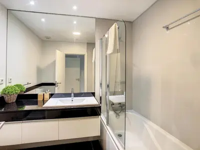 a bathroom with a sink and a shower and a tub at Alameda Apartment by LovelyStay in Funchal