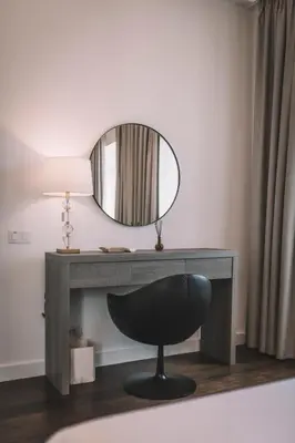 a desk with a mirror and a black chair at QUINTA TORRINHA PANORAMA Apartment in Funchal