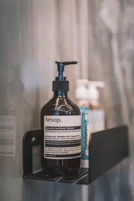 a bottle of asxs soap sitting on a shelf at QUINTA TORRINHA PANORAMA Apartment in Funchal