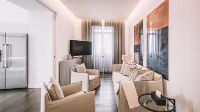 a living room with white furniture and a tv at QUINTA TORRINHA PANORAMA Apartment in Funchal