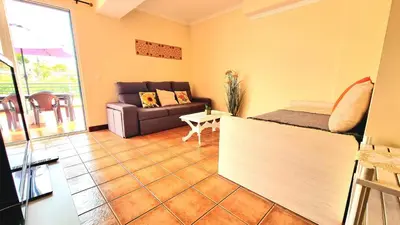 a living room with a couch and a table at Casa Gouveia in Porto Santo