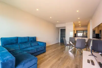 a living room with a blue couch and a table at FLH Amazing Ocean View with Balcony in Santa Cruz