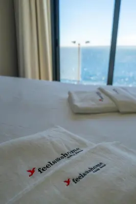 a close up of two towels on a bed with a window at FLH Amazing Ocean View with Balcony in Santa Cruz