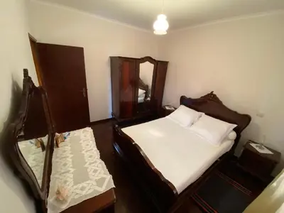 a small bedroom with a bed and a mirror at Maria's House - São Jorge in Santana