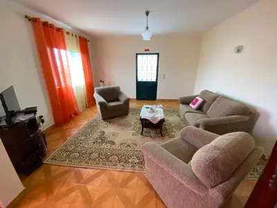 a living room with two couches and a table at Maria's House - São Jorge in Santana