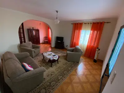 a living room with two couches and a table at Maria's House - São Jorge in Santana