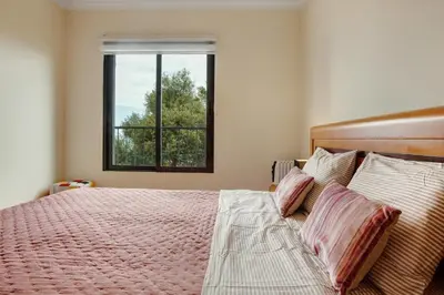 a bedroom with a large bed with a window at Costa Avila 2 in Caniço