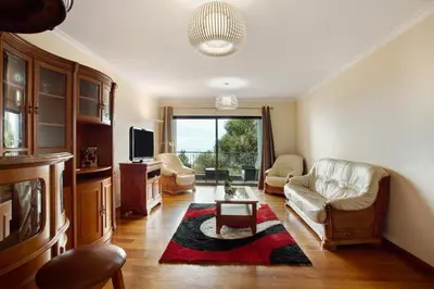 a living room with a couch and a table at Costa Avila 2 in Caniço