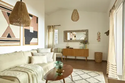 a living room with a couch and a table at Yeotown Madeira Wellness Hotel and Nature Stay in Arco da Calheta